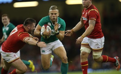 080815 - Wales v Ireland, Dove Men Tests 2015 - Ian Madigan of Ireland is tackled by Rob Evans of Wales 