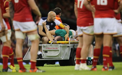 080815 - Wales v Ireland, Dove Men Tests 2015 - Tommy O'Donnell of Ireland is taken from the pitch after being injured