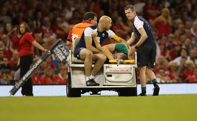 080815 - Wales v Ireland, Dove Men Tests 2015 - Tommy O'Donnell of Ireland is taken from the pitch after being injured