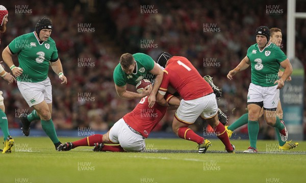 080815 - Wales v Ireland - Dove Mens Series - Iain Henderson of Ireland is tackled by Aaron Jarvis and Nicky Smith of Wales