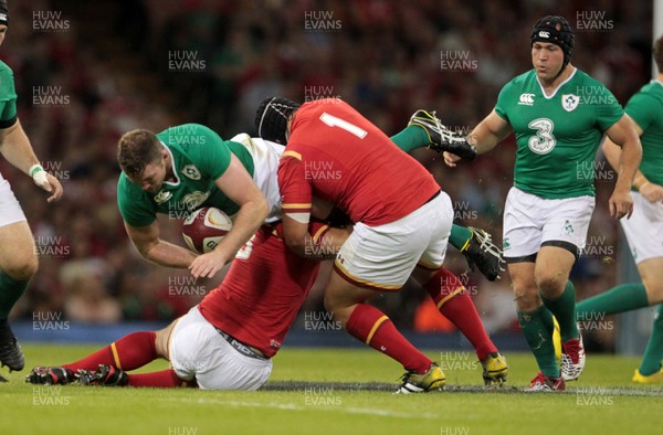 080815 - Wales v Ireland - Dove Mens Series - Iain Henderson of Ireland is tackled by Aaron Jarvis and Nicky Smith of Wales