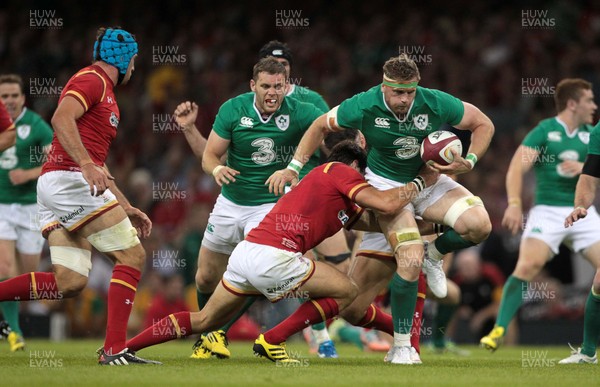 080815 - Wales v Ireland - Dove Mens Series - Jamie Heaslip of Ireland is tackled by James Hook and Mike Phillips of Wales