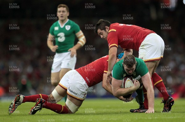 080815 - Wales v Ireland - Dove Mens Series - Iain Henderson of Ireland is tackled by Justin Tipuric and Aaron Jarvis of Wales