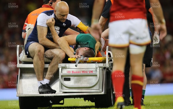 080815 - Wales v Ireland, Dove Men Tests 2015 - Tommy O'Donnell of Ireland is taken from the pitch after being injured