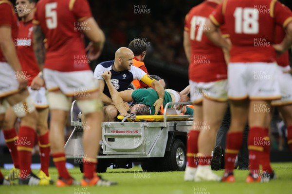 080815 - Wales v Ireland, Dove Men Tests 2015 - Tommy O'Donnell of Ireland is taken from the pitch after being injured