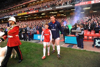 12.03.11 - Wales v Ireland - RBS Six Nations 2011 - Matthew Rees of Wales leads his team onto the field with mascot Tomas Rees. 