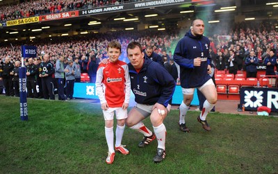 12.03.11 - Wales v Ireland - RBS Six Nations 2011 - Matthew Rees of Wales leads his team onto the field with mascot Tomas Rees. 