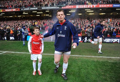 12.03.11 - Wales v Ireland - RBS Six Nations 2011 - Matthew Rees of Wales leads his team onto the field with mascot Tomas Rees. 