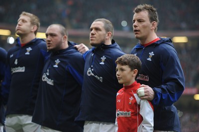 12.03.11 - Wales v Ireland - RBS Six Nations 2011 - Bradley Davies, Craig Mitchell, Paul James and Matthew Rees line-up for the national anthems with match mascot Tomas Rees. 