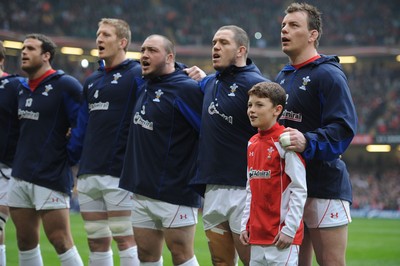 12.03.11 - Wales v Ireland - RBS Six Nations 2011 - Jamie Roberts, Bradley Davies, Craig Mitchell, Paul James and Matthew Rees line-up for the national anthems with match mascot Tomas Rees. 