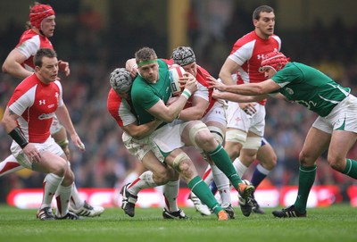 12.03.11 Wales v Ireland ... Ireland's Jamie Heaslip is tackled by Dan Lydiate and Jonathan Davies. 