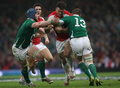 12.03.11... Wales v Ireland, RBS 6 Nations -  Wales' Jamie Roberts is tackled by Ireland's Brian O'Driscoll and Ireland's Sean O'Brien  