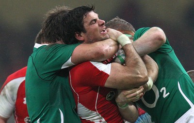 12.03.11... Wales v Ireland, RBS 6 Nations -  Wales' Mike Phillips is tackled by Ireland's Donncha O'Callaghan and Jamie Heaslip  
