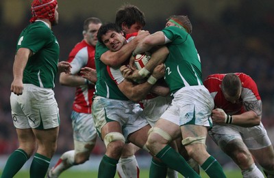 12.03.11... Wales v Ireland, RBS 6 Nations -  Wales' Mike Phillips is tackled by Ireland's Donncha O'Callaghan and Jamie Heaslip  