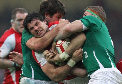 12.03.11... Wales v Ireland, RBS 6 Nations -  Wales' Mike Phillips is tackled by Ireland's Donncha O'Callaghan and Jamie Heaslip  