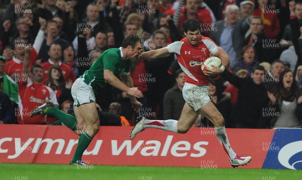 12.03.11 - Wales v Ireland - RBS Six Nations 2011 - Mike Phillips of Wales holds off Tommy Bowe of Ireland to score try. 