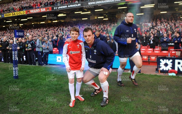 12.03.11 - Wales v Ireland - RBS Six Nations 2011 - Matthew Rees of Wales leads his team onto the field with mascot Tomas Rees. 