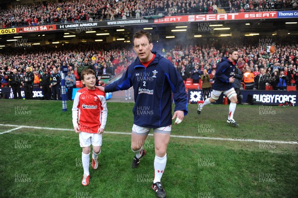 12.03.11 - Wales v Ireland - RBS Six Nations 2011 - Matthew Rees of Wales leads his team onto the field with mascot Tomas Rees. 