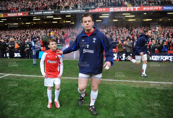 12.03.11 - Wales v Ireland - RBS Six Nations 2011 - Matthew Rees of Wales leads his team onto the field with mascot Tomas Rees. 