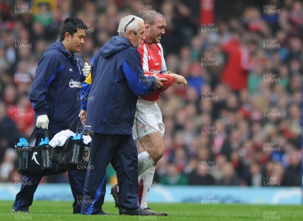 12.03.11 - Wales v Ireland - RBS Six Nations 2011 - Craig Mitchell of Wales leaves the field with team doctor Prof. John Williams and National Performance Medical Manager Prav Mathema. 