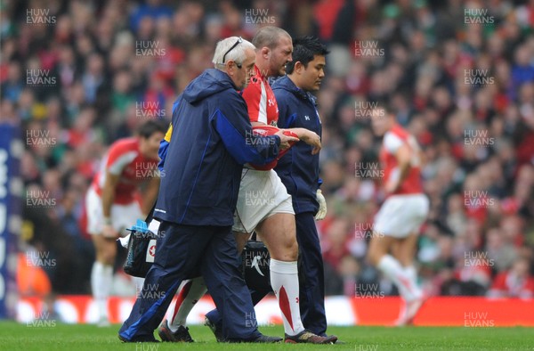 12.03.11 - Wales v Ireland - RBS Six Nations 2011 - Craig Mitchell of Wales leaves the field with team doctor Prof. John Williams and National Performance Medical Manager Prav Mathema. 