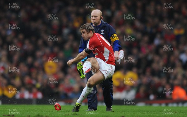 12.03.11 - Wales v Ireland - RBS Six Nations 2011 - Leigh Halfpenny of Wales kicks as Kicking coach Neil Jenkins looks on. 