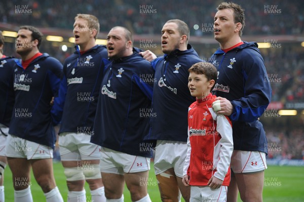 12.03.11 - Wales v Ireland - RBS Six Nations 2011 - Jamie Roberts, Bradley Davies, Craig Mitchell, Paul James and Matthew Rees line-up for the national anthems with match mascot Tomas Rees. 