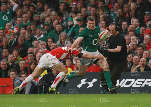 12.03.11 Wales v Ireland - RBS 6 Nations Championship-  Ireland's Gordon D'Arcy is tackled by Wales' Leigh Halfpenny. 