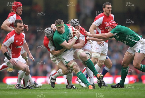 12.03.11 Wales v Ireland ... Ireland's Jamie Heaslip is tackled by Dan Lydiate and Jonathan Davies. 