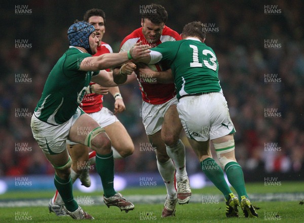 12.03.11... Wales v Ireland, RBS 6 Nations -  Wales' Jamie Roberts is tackled by Ireland's Brian O'Driscoll and Ireland's Sean O'Brien  