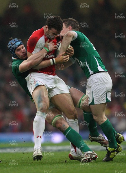 12.03.11... Wales v Ireland, RBS 6 Nations -  Wales' Jamie Roberts is tackled by Ireland's Brian O'Driscoll and Ireland's Sean O'Brien  