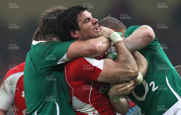 12.03.11... Wales v Ireland, RBS 6 Nations -  Wales' Mike Phillips is tackled by Ireland's Donncha O'Callaghan and Jamie Heaslip  