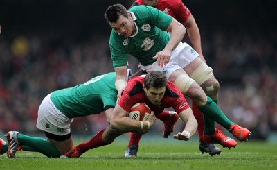 140315 - Wales v Ireland - RBS 6 Nations - Dan Biggar of Wales is tackled by Robbie Henshaw and Peter OÕMahony of Ireland