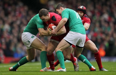 140315 - Wales v Ireland - RBS 6 Nations - George North of Wales is tackled by Robbie Henshaw and Jonny Sexton of Ireland