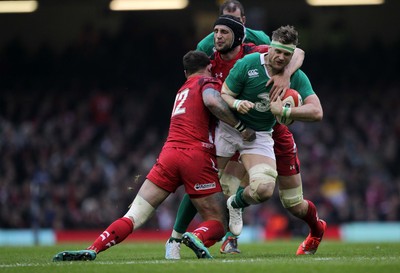 140315 - Wales v Ireland - RBS 6 Nations - Jamie Heaslip of Ireland is tackled by Jamie Roberts and Luke Charteris of Wales