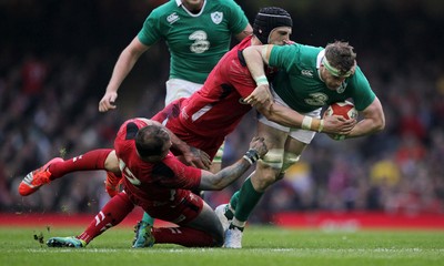 140315 - Wales v Ireland - RBS 6 Nations - Jamie Heaslip of Ireland is tackled by Jamie Roberts and Luke Charteris of Wales