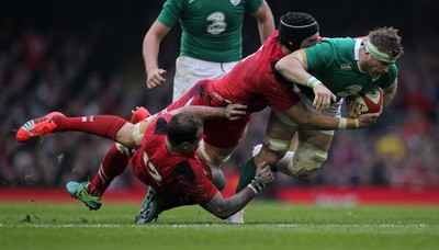 140315 - Wales v Ireland - RBS 6 Nations - Jamie Heaslip of Ireland is tackled by Jamie Roberts and Luke Charteris of Wales