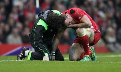 140315 - Wales v Ireland - RBS 6 Nations - Jamie Roberts of Wales is seen to by a medic