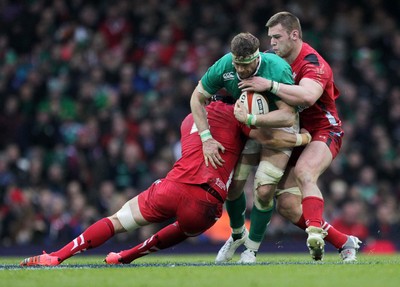 140315 - Wales v Ireland - RBS 6 Nations - Jamie Heaslip of Ireland is tackled by Luke Charteris and Dan Lydiate of Wales