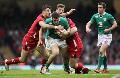 140315 - Wales v Ireland - RBS 6 Nations - Peter OÕMahony of Ireland is tackled by Mike Phillips and Aaron Jarvis of Wales