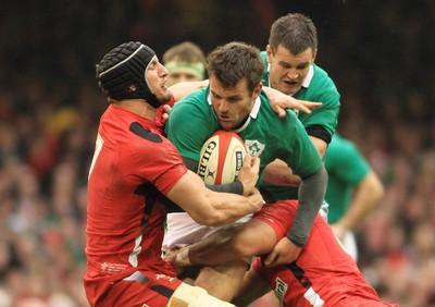 140315 - Wales v Ireland - RBS 6 Nations -Jarad Payne of Ireland is tackled by Sam Warburton(L) and Taulupe faletau of Wales