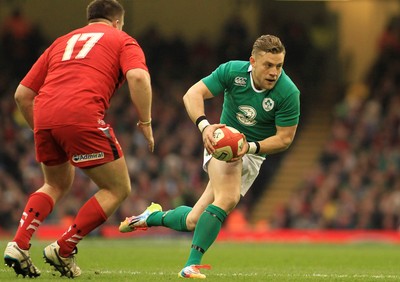 140315 - Wales v Ireland - RBS 6 Nations -Ian Madigan of Ireland takes on Rob Evans of Wales