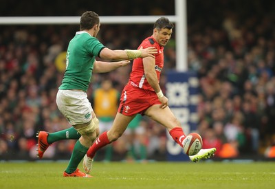 140315 - Wales v Ireland, RBS 6 Nations 2015 - Mike Phillips of Wales kicks past Peter OÕMahony of Ireland