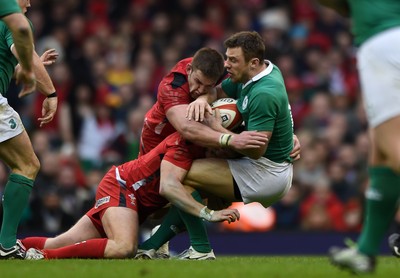 140315 - Wales v Ireland - RBS Six Nations - Tommy Bowe of Ireland is tackled by Dan Biggar and Dan Lydiate of Wales