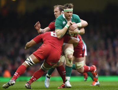 140315 - Wales v Ireland - RBS Six Nations - Ireland's Jamie Heaslip is tackled by Taulupe Faletau and Alun Wyn Jones