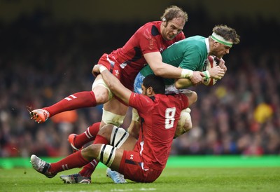 140315 - Wales v Ireland - RBS Six Nations - Ireland's Jamie Heaslip is tackled by Taulupe Faletau and Alun Wyn Jones