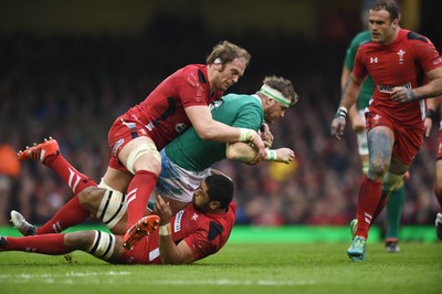 140315 - Wales v Ireland - RBS Six Nations - Ireland's Jamie Heaslip is tackled by Taulupe Faletau and Alun Wyn Jones