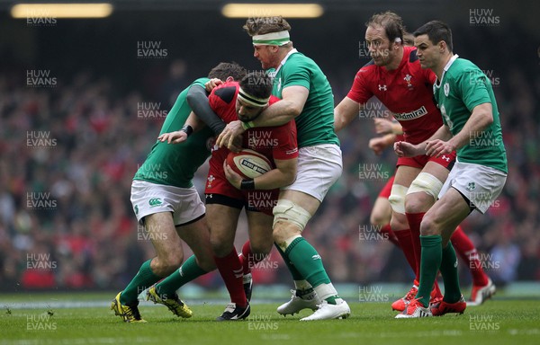 140315 - Wales v Ireland - RBS 6 Nations - Scott Baldwin of Wales is tackled by Jared Payne and Jamie Heaslip of Ireland