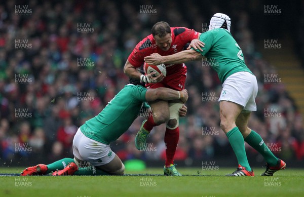 140315 - Wales v Ireland - RBS 6 Nations - Jamie Roberts of Walesis tackled by Sean OÕBrien and Rory Best of Ireland