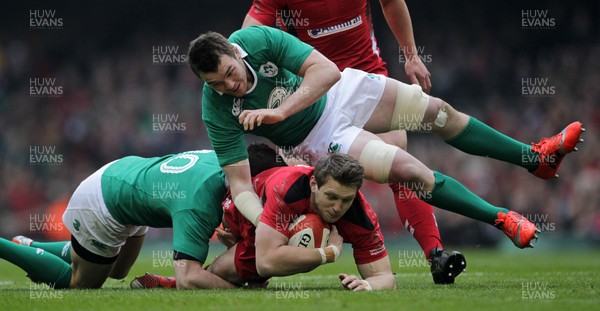 140315 - Wales v Ireland - RBS 6 Nations - Dan Biggar of Wales is tackled by Robbie Henshaw and Peter OÕMahony of Ireland